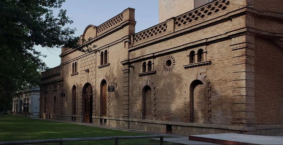 Fachada histórica de ladrillo y jardín de Bodega Weinert